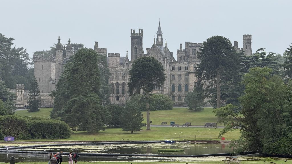 View of Alton Towers from a distance with a lake in front of it.